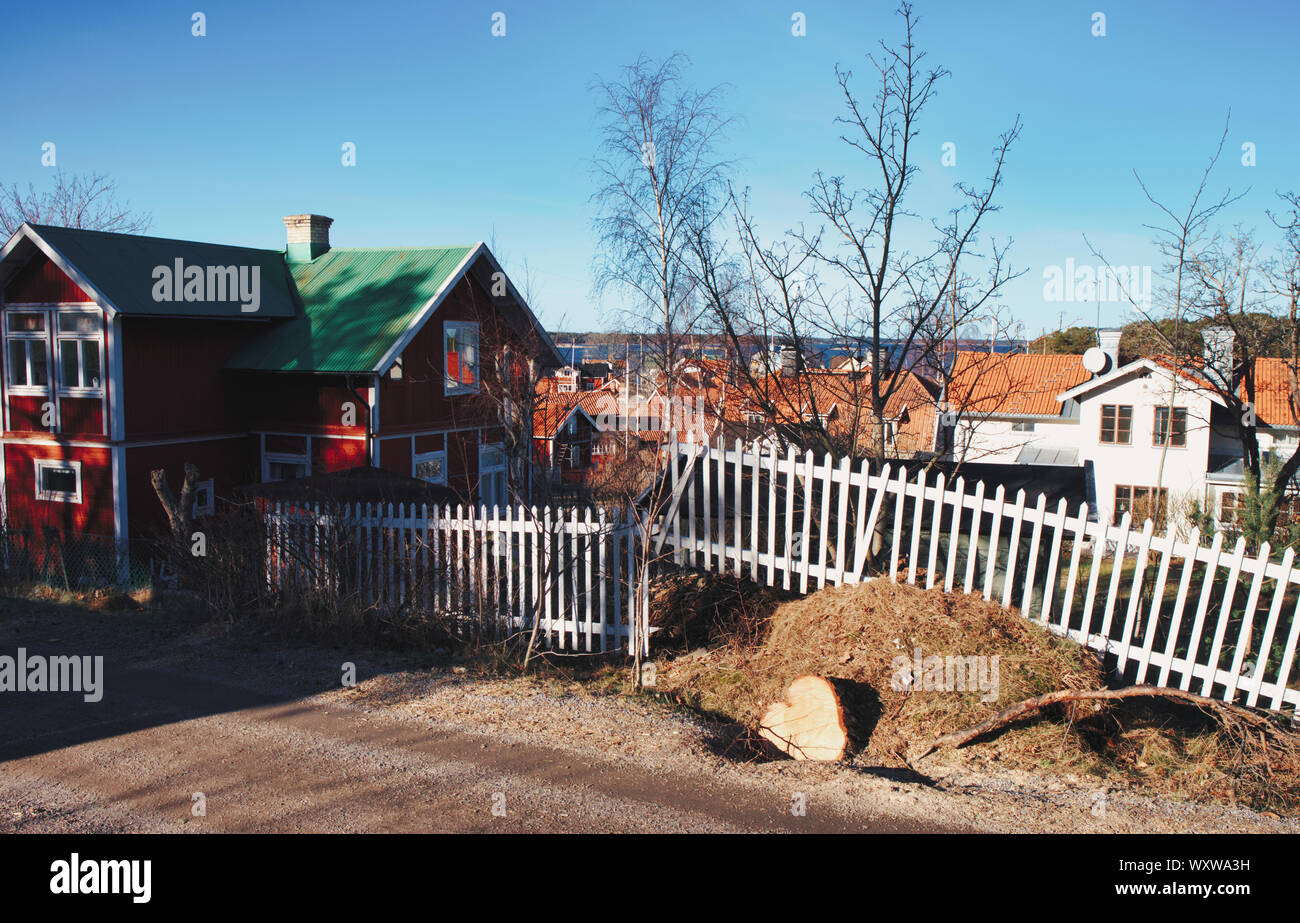 Broken white wooden fence on the island of Sandhamn, Stockholm archipelago, Sweden Stock Photo