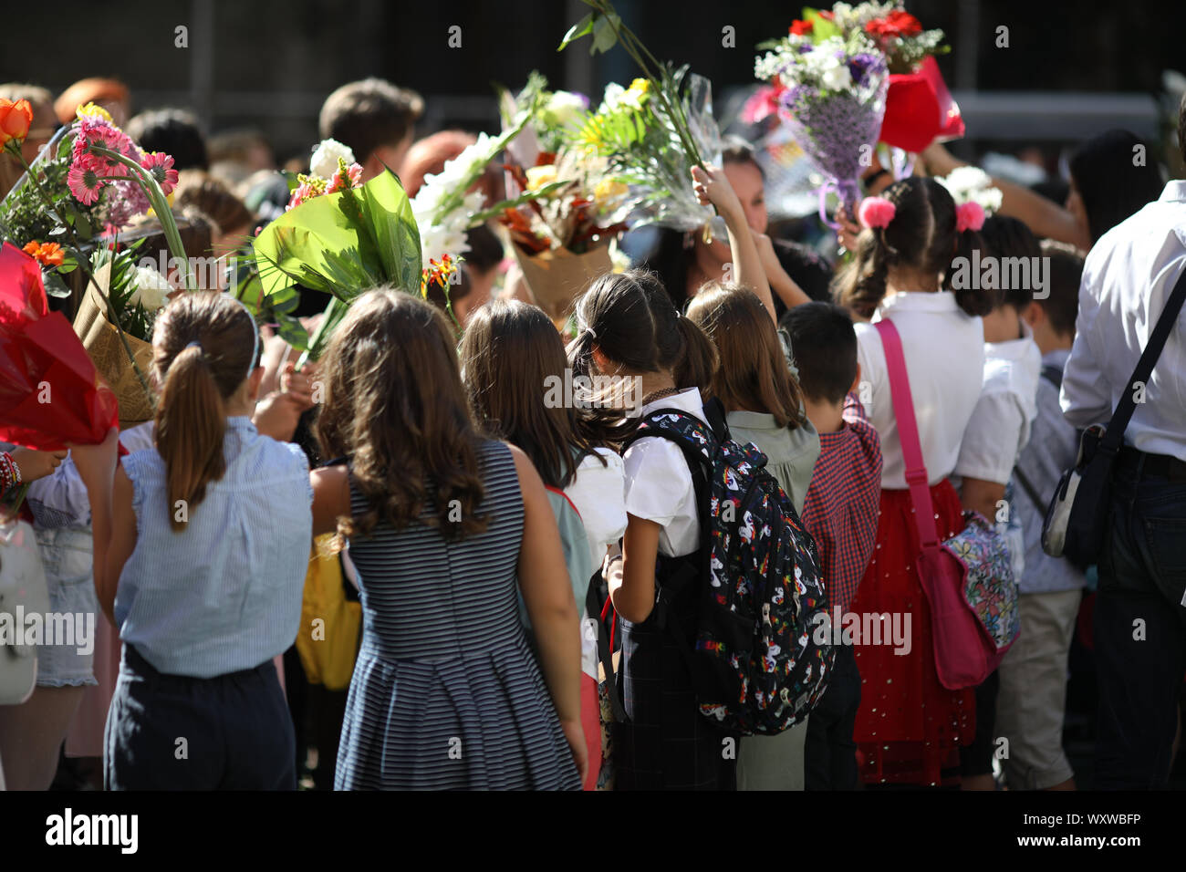 Children hold flowers in their first day of school Stock Photo