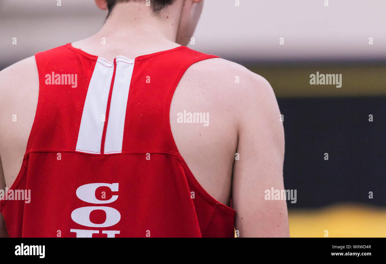 A high school track and field athlete in deep concentration before he