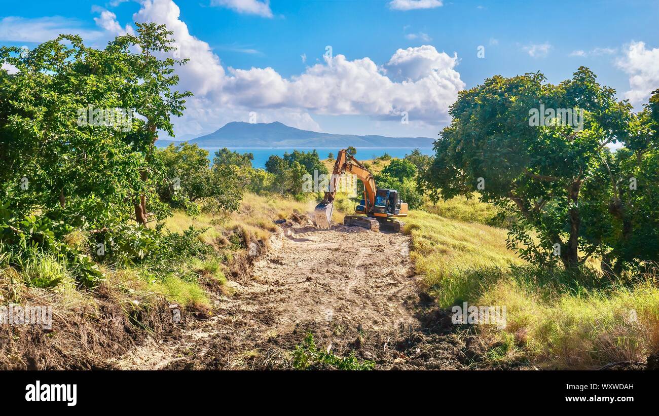 Environmental damage created by the tourist industry, as a new public road is being constructed to provide access to develop virgin land for tourism. Stock Photo