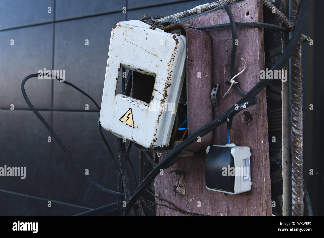 Self made rusty electric box. Energized electrical equipment. Dangerous, high voltage! Stock Photo