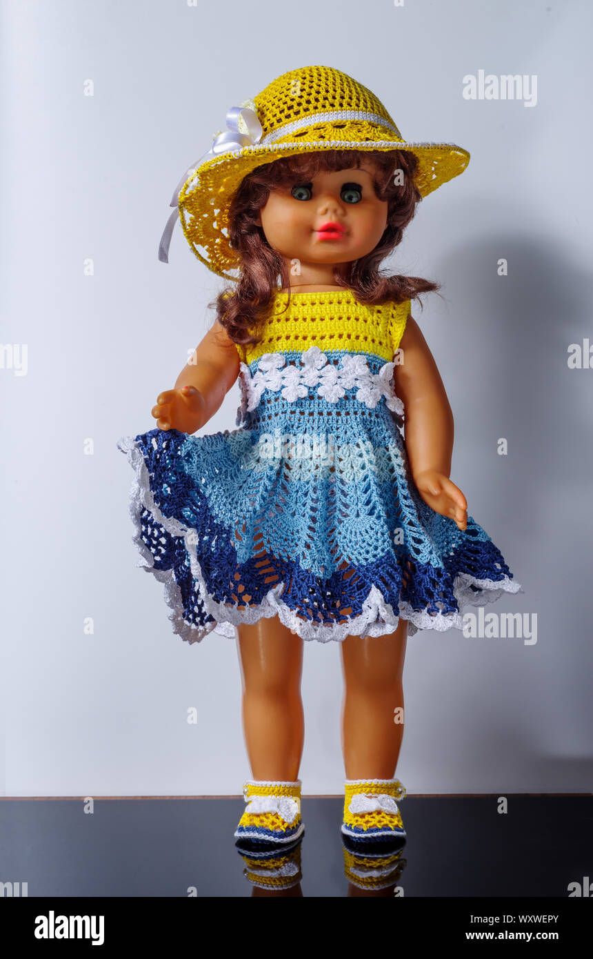 Old vintage doll in a beautiful outfit, in dress, shoes and hat Stock Photo