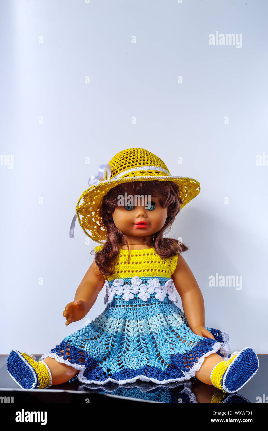 Old vintage doll in a beautiful outfit, in dress, shoes and hat Stock Photo