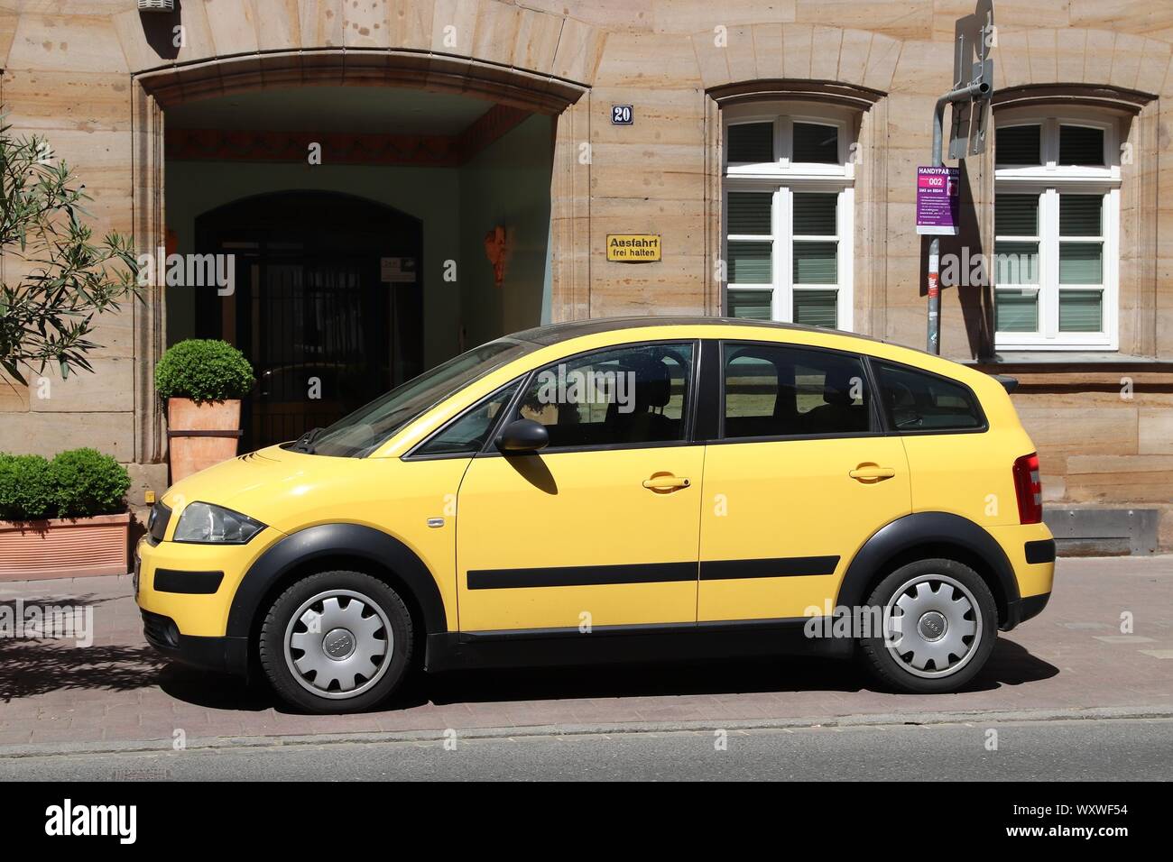 FURTH, GERMANY - MAY 6, 2018: Yellow Audi A2 compact mini car parked in Germany. The car was designed by Belgian car designer Luc Donckerwolke. Stock Photo