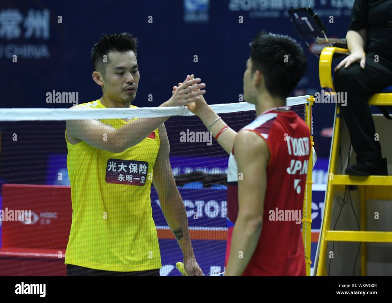 Chinese professional badminton player Lin Dan, left, competes against Japanese professional badminton player Kento Momota, right, at the first round of men's single of VICTOR China Open 2019, in Changzhou city, east China's Jiangsu province, 17 September 2019. Chinese professional badminton player Lin Dan was defeated by Japanese professional badminton player Kento Momota with 0-2 at the first round of men's single of VICTOR China Open 2019, in Changzhou city, east China's Jiangsu province, 17 September 2019. Stock Photo