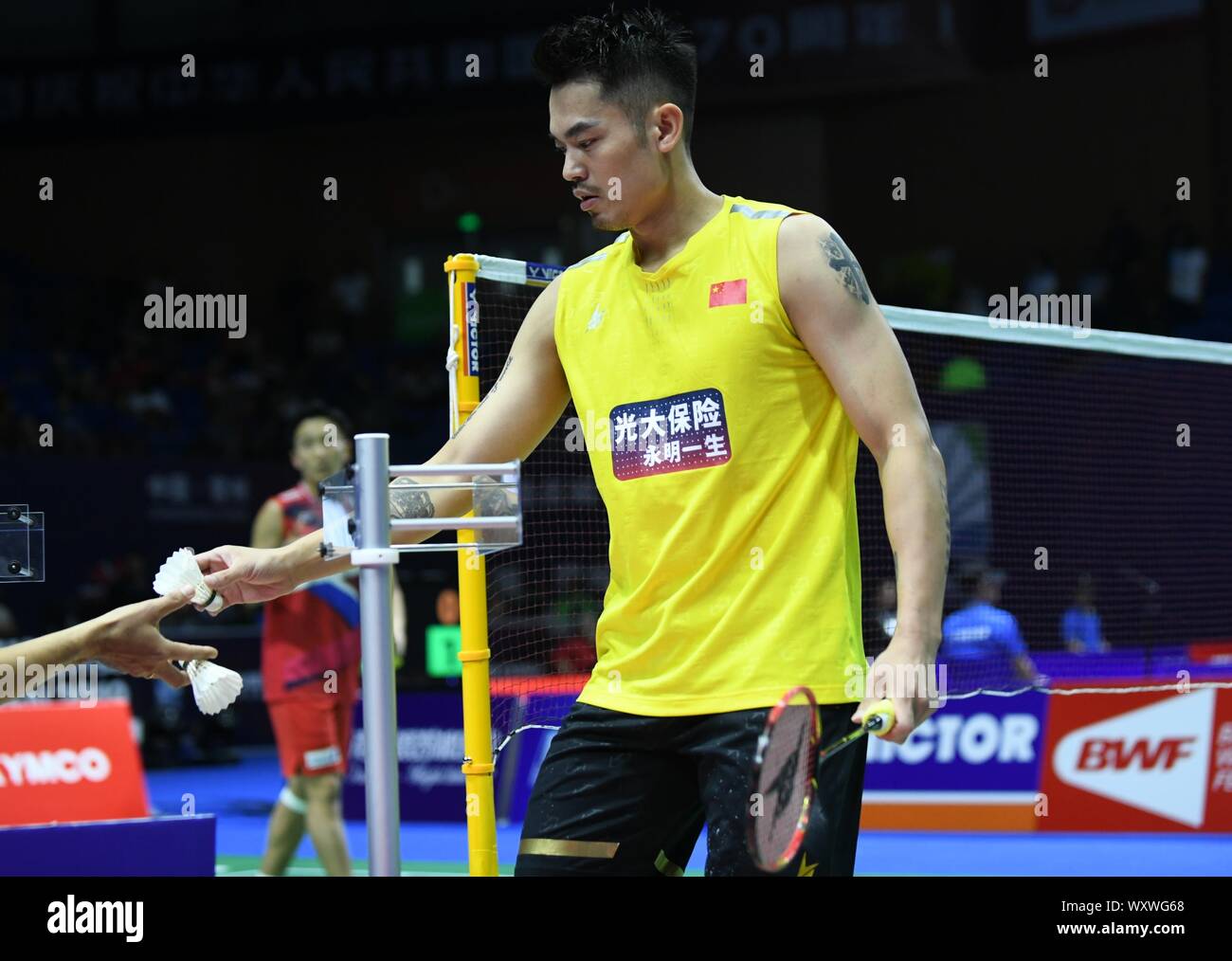 Chinese professional badminton player Lin Dan competes against Japanese professional badminton player Kento Momota at the first round of men's single of VICTOR China Open 2019, in Changzhou city, east China's Jiangsu province, 17 September 2019. Chinese professional badminton player Lin Dan was defeated by Japanese professional badminton player Kento Momota with 0-2 at the first round of men's single of VICTOR China Open 2019, in Changzhou city, east China's Jiangsu province, 17 September 2019. Stock Photo