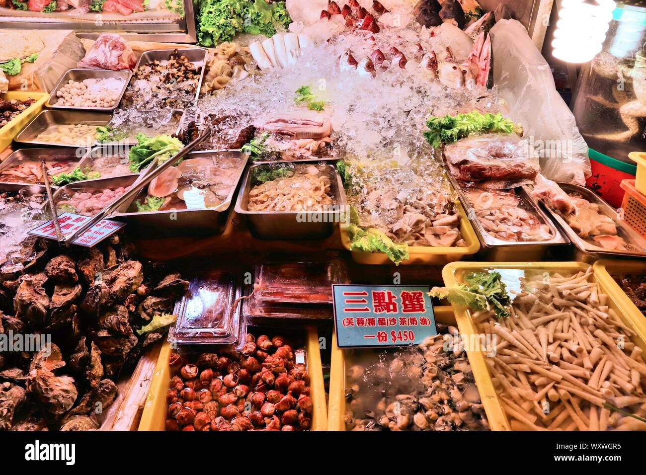 KEELUNG, TAIWAN - NOVEMBER 22, 2018: Sea food selection at famous Miaokou Night Market in Keelung, Taiwan. Night markets are essential part of Taiwane Stock Photo