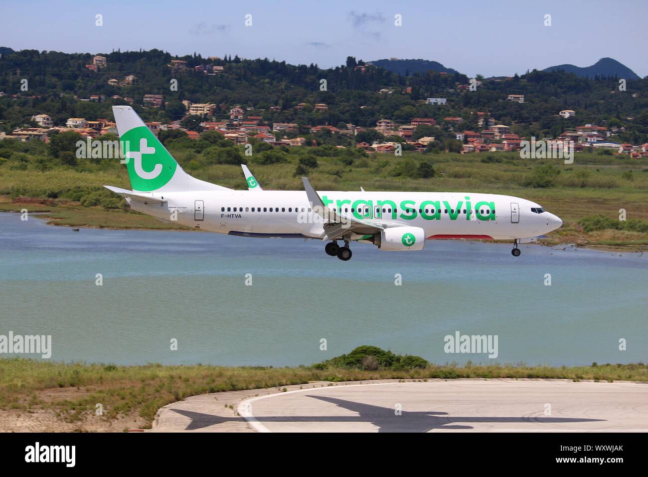 CORFU, GREECE - JUNE 5, 2016: Transavia Boeing 737-800 arrives at Corfu International Airport, Greece. Transavia is a Dutch low-cost airline owned by Stock Photo