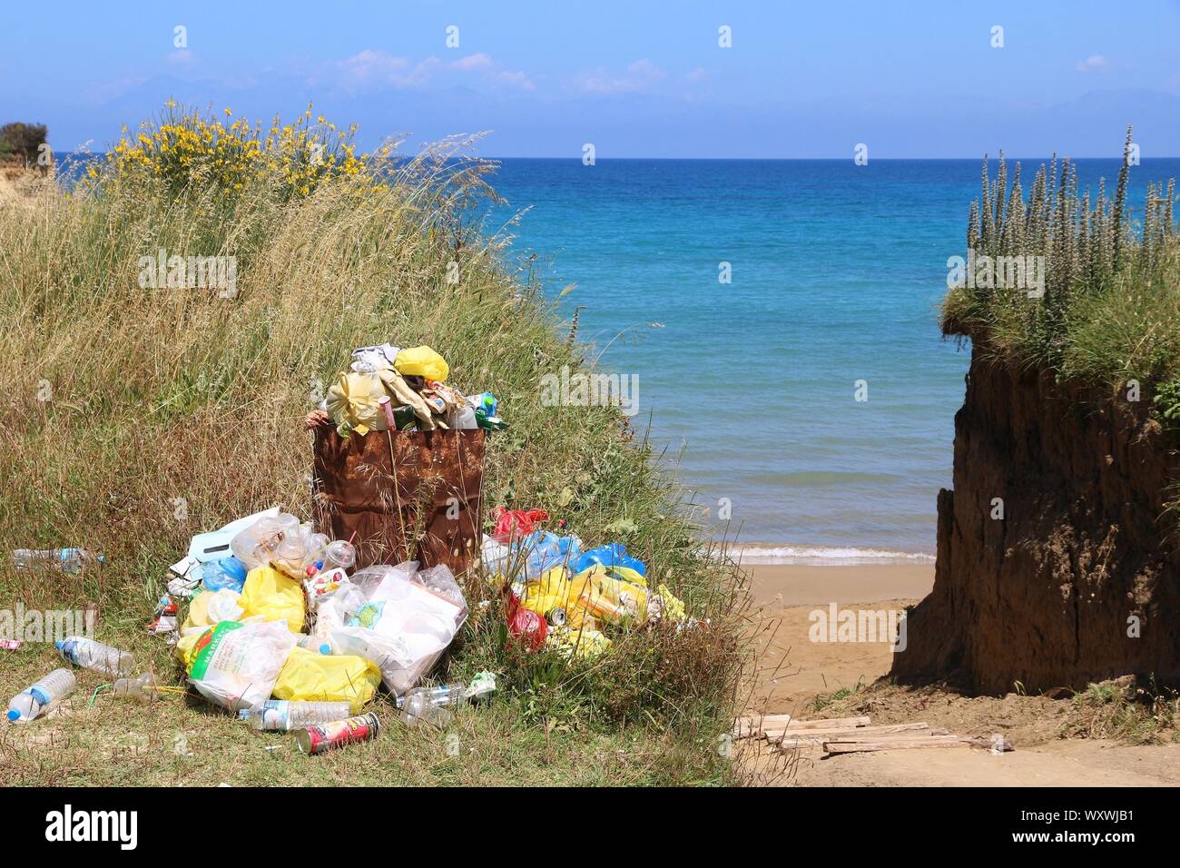 CORFU, GREECE - MAY 31, 2016: Waste disposal next to the beach in Sidari, Corfu Island, Greece. 558,000 tourists visited Corfu in 2012. Stock Photo