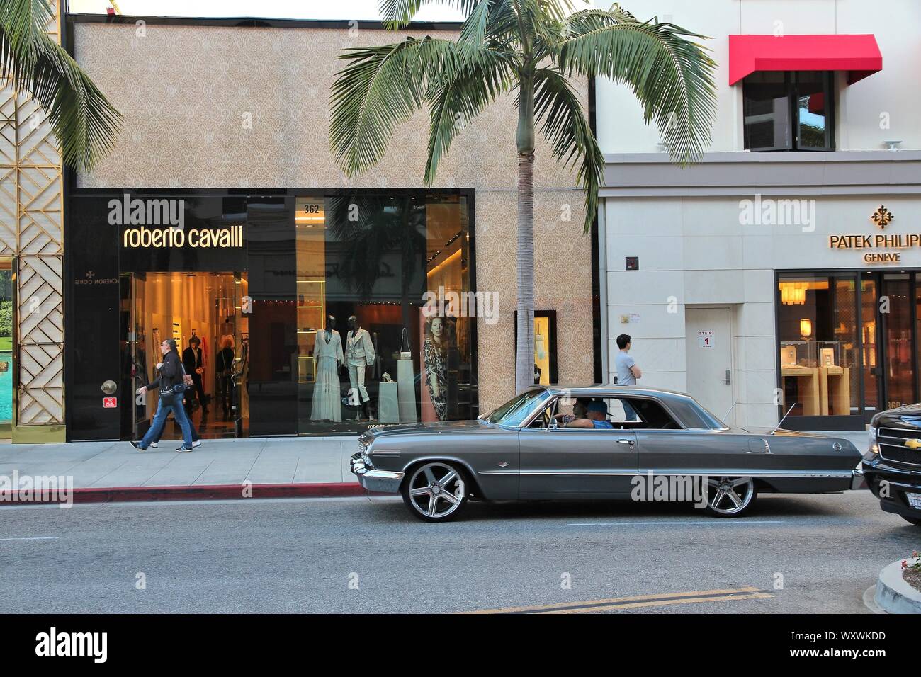 LOS ANGELES, USA - APRIL 5, 2014: People walk in Beverly Hills, Los Angeles. Beverly Hills is a district of upscale shopping and rich celebrities. Stock Photo