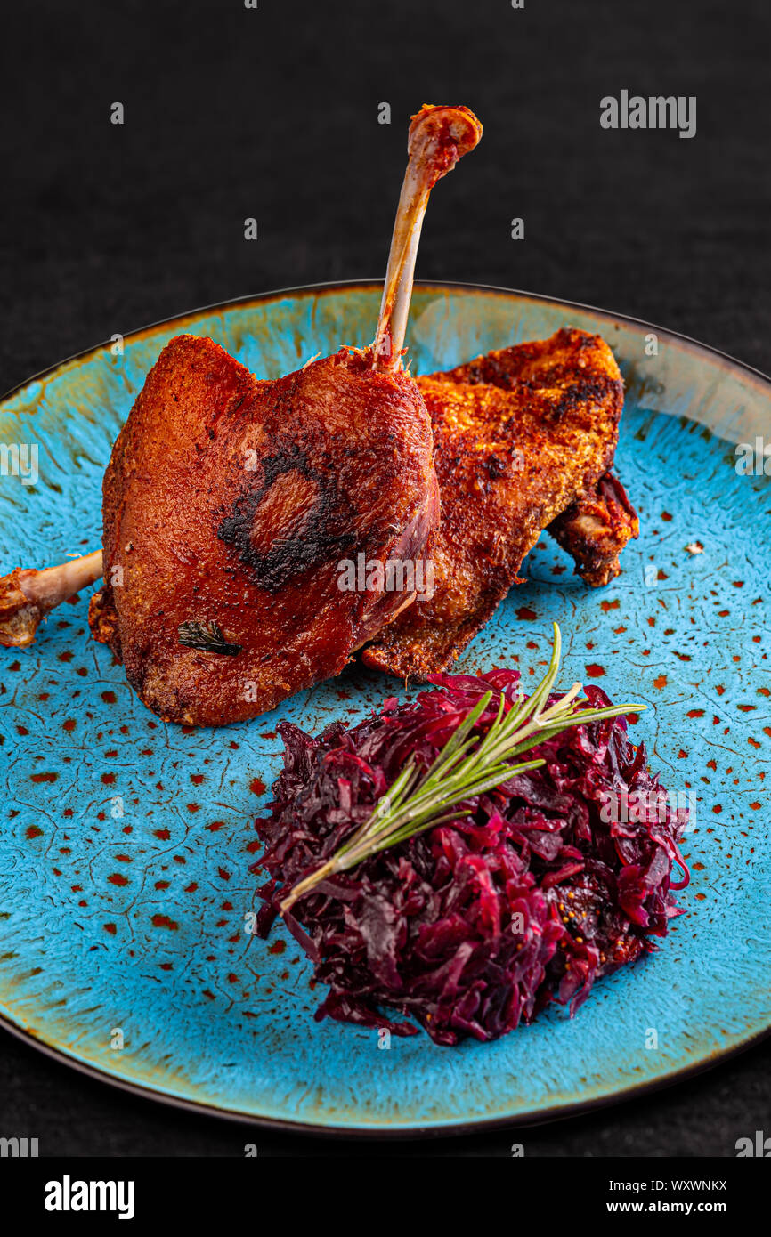 Confit duck legs and red cabbage with dried prunes Stock Photo - Alamy