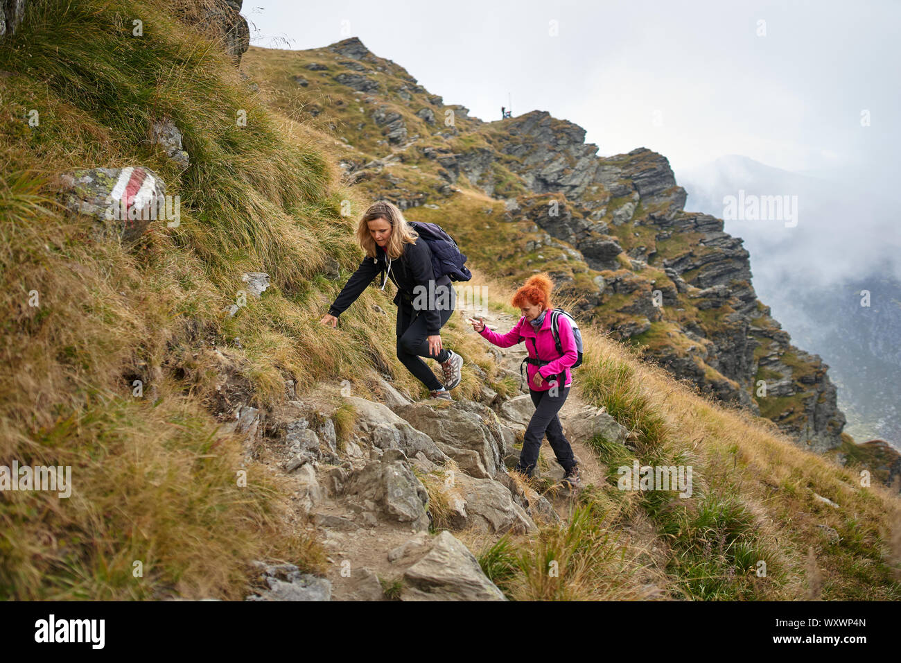 Two tourist backpacks climb hi-res stock photography and images - Alamy
