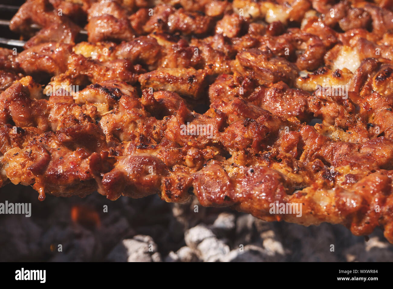 Grilling Marinated Shashlik On A Grill. Shashlik Is A Form Of Shish Kebab  Popular In Eastern, Central Europe And Other Places. Shashlyk (meaning  Skewered Meat) Was Originally Made Of Lamb. Stock Photo