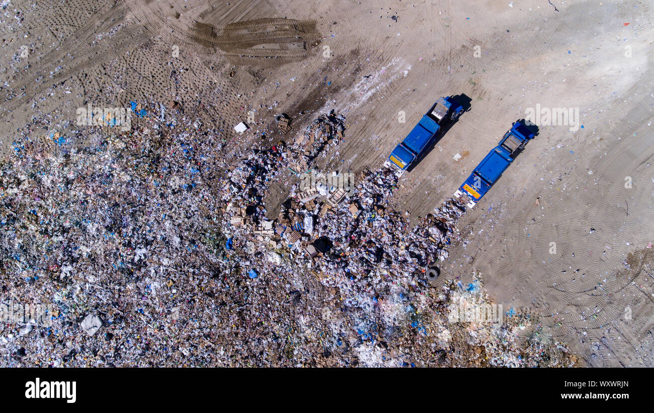 dumping of trash in a landfill by two trucks Stock Photo Alamy