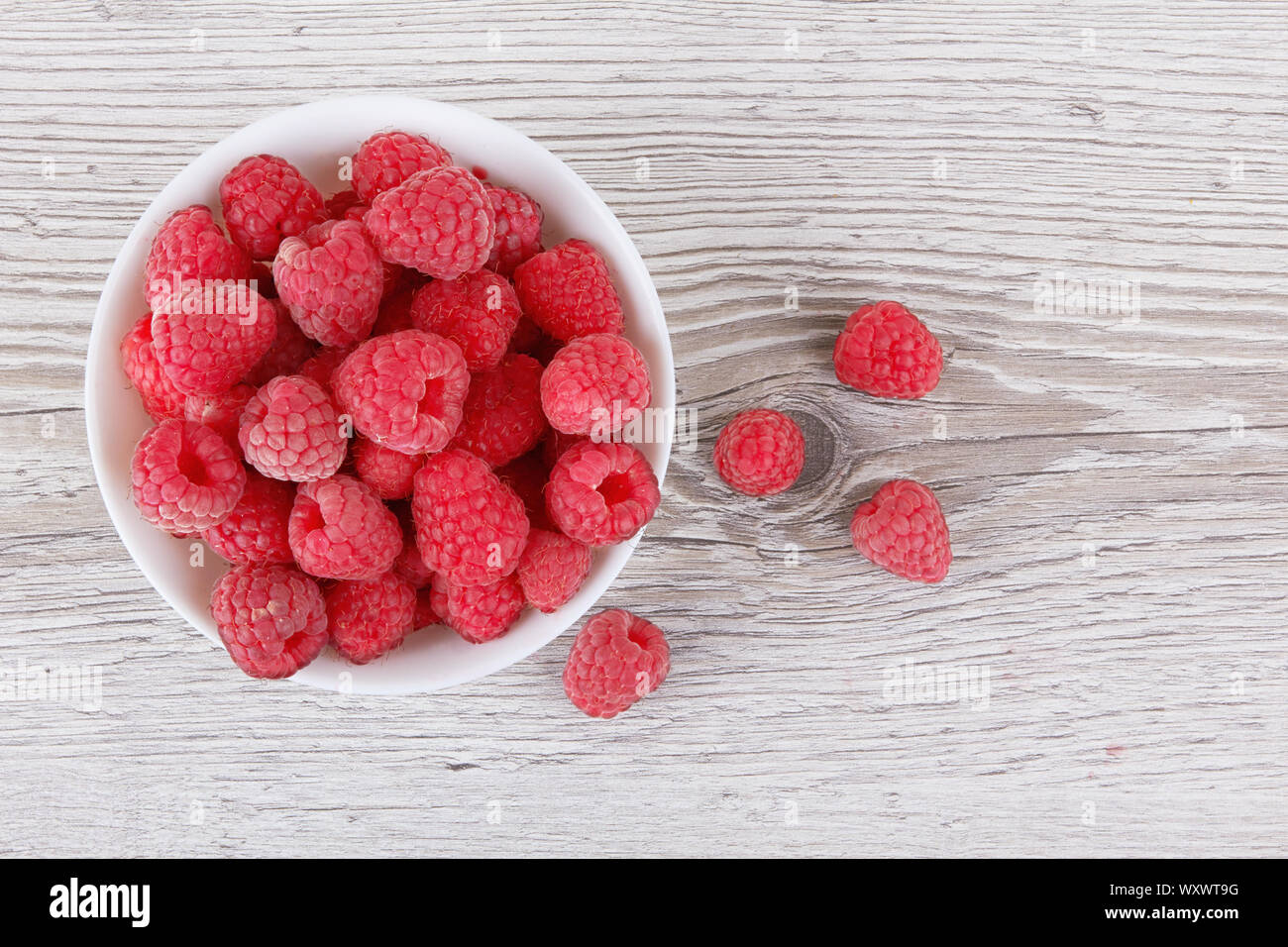 Raspberry fruit closeup isolated on wooden background Stock Photo