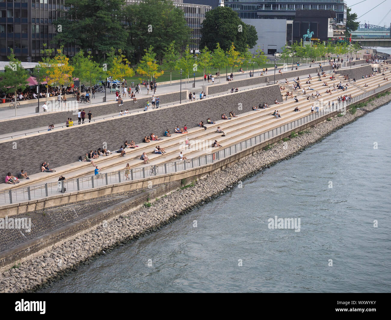 KOELN, GERMANY - CIRCA AUGUST 2019: People sunbathing on Rheinboulevard  riverside walkway with steps overlooking the river Rhine, old town and  cathedr Stock Photo - Alamy