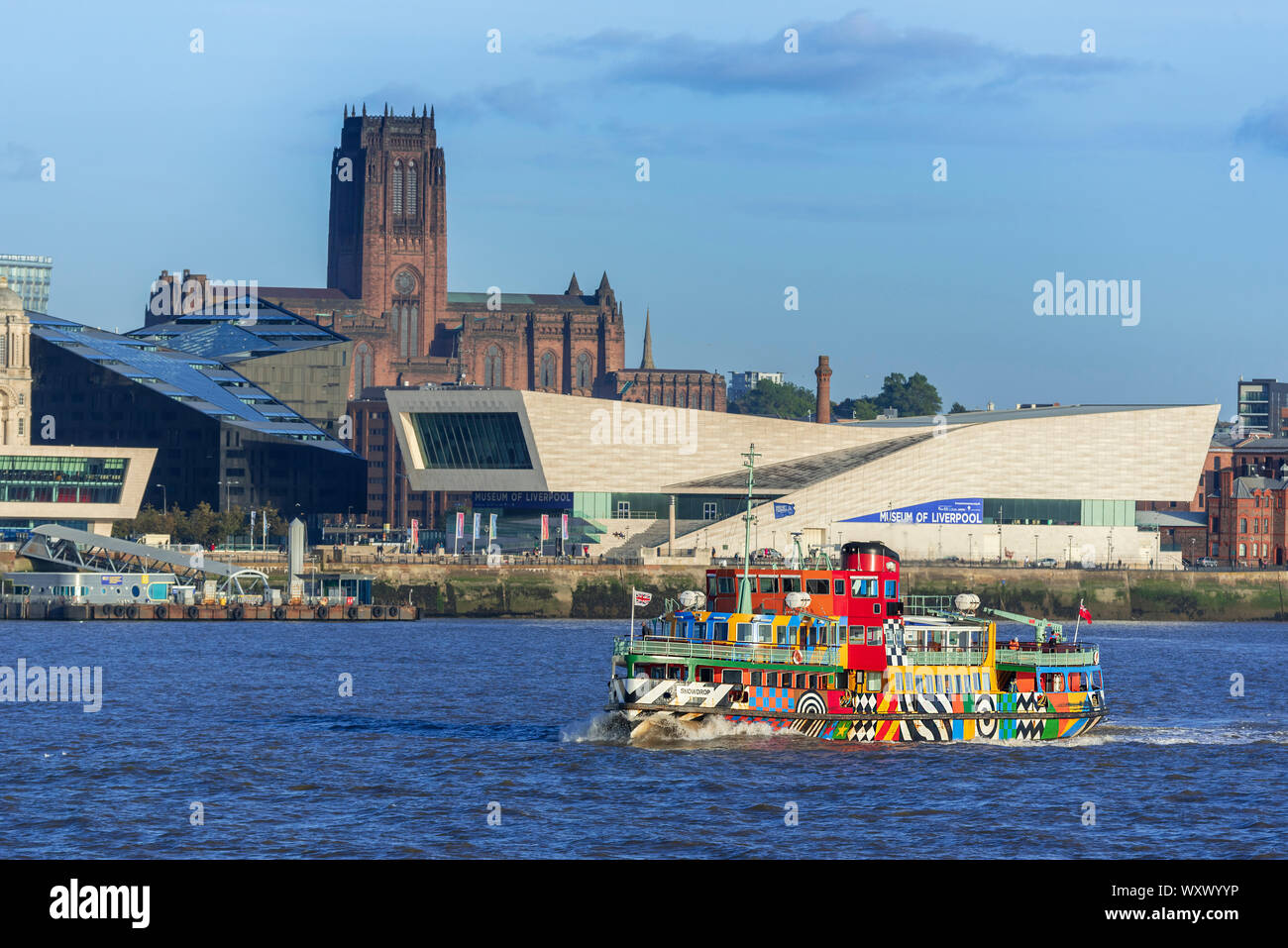 Liverpool waterfront in evening sunlight with the Anglican cathedral and Museum of Liverpool. Mersey ferry the Snowdrop. Dazzle ferry Stock Photo