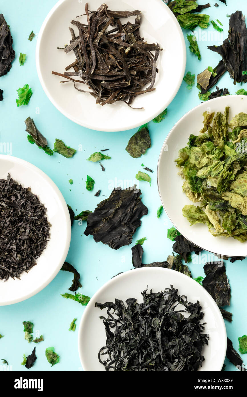 Dry seaweed, sea vegetables, overhead shot on a teal blue background