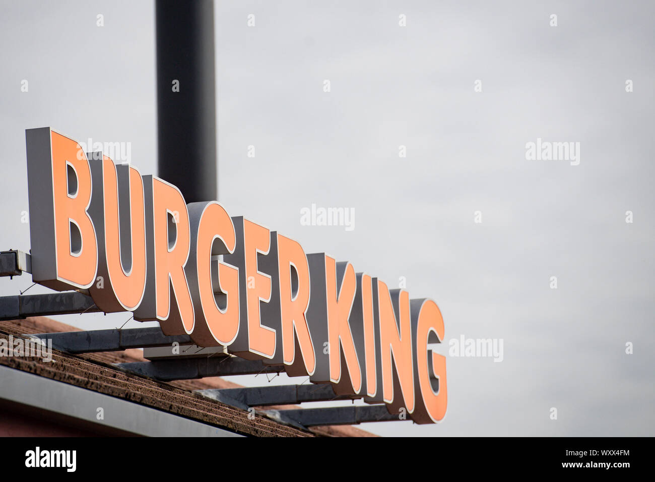 A sign for a Burger King drive thru restaurant. The fast food chain has announced that they are removing all plastic toys from its children's meals served in the UK from Thursday to save an estimated 320 tonnes of waste annually. PA Photo. Picture date: Wednesday September 18, 2019. Burger King said the move was part of a wider commitment to reduce its use of plastic, and admitted it was 'spurred on' by Southampton sisters Ella and Caitlin McEwan's petition against the use of plastic toys in children's meals. See PA story CONSUMER BurgerKing. Photo credit should read: Jacob King/PA Wire Stock Photo