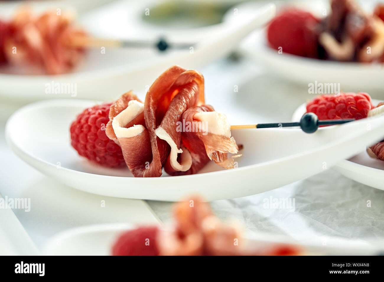 Delicious canapes hamon with raspberries. Concept of food, restaurant ...