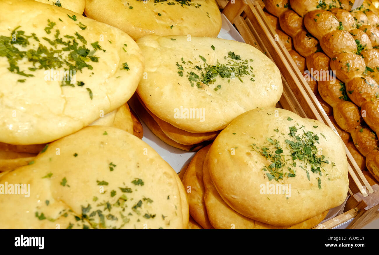 Different bread on the shelves in the bakery. Fresh rolls in