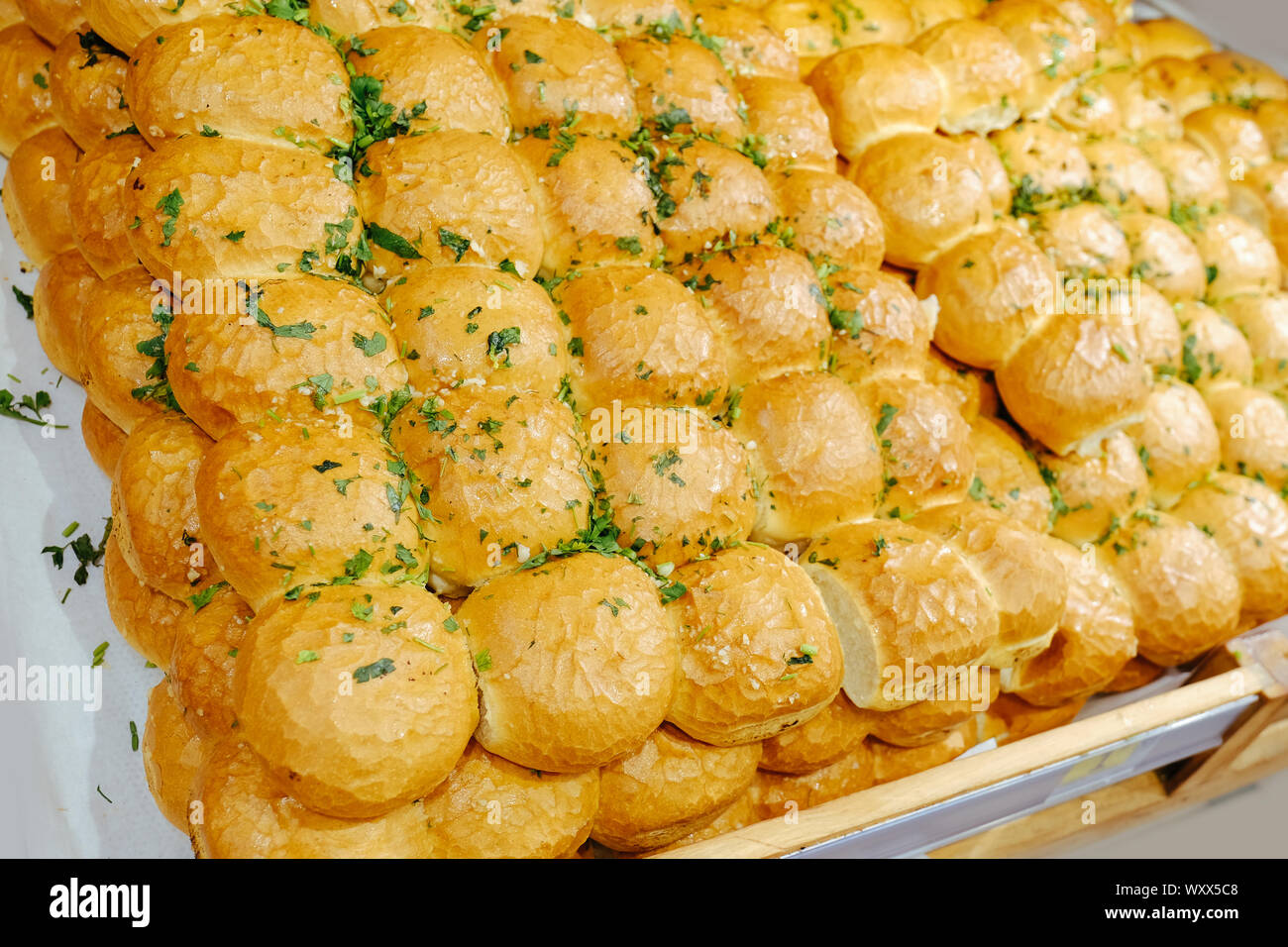 Bread with garlic on the shelves in the bakery. Fresh rolls in