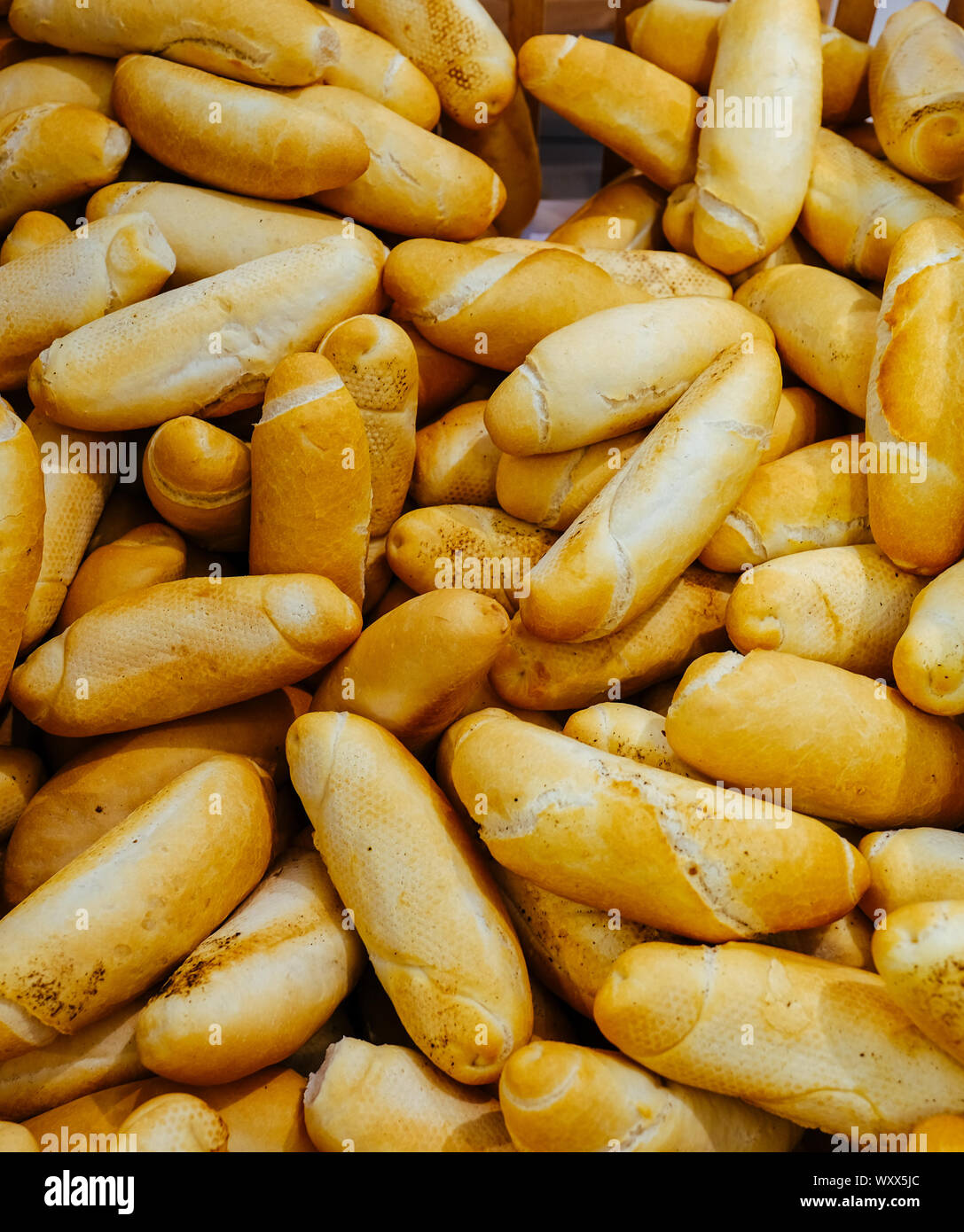Different bread on the shelves in the bakery. Fresh rolls in
