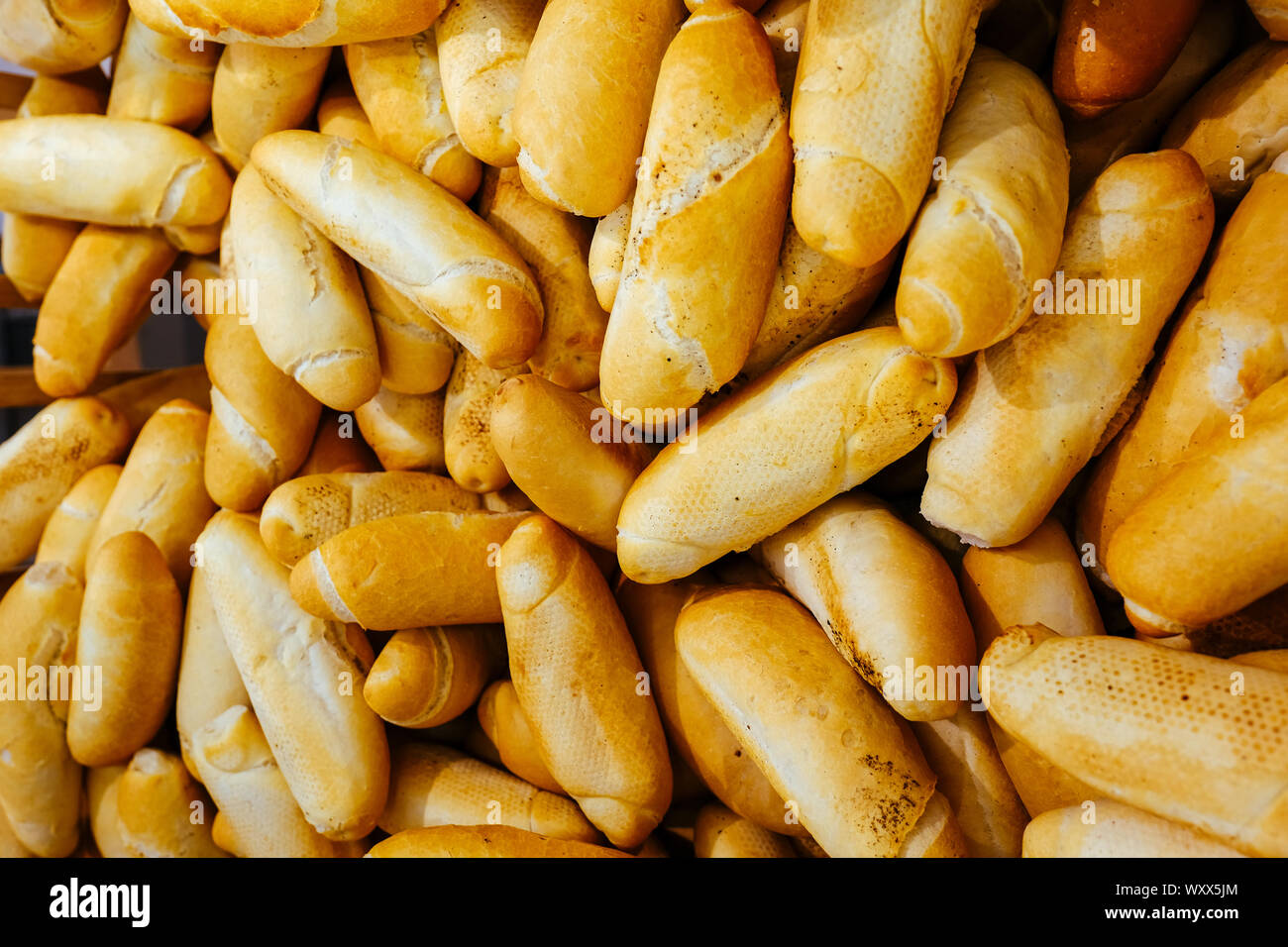 Different bread on the shelves in the bakery. Fresh rolls in