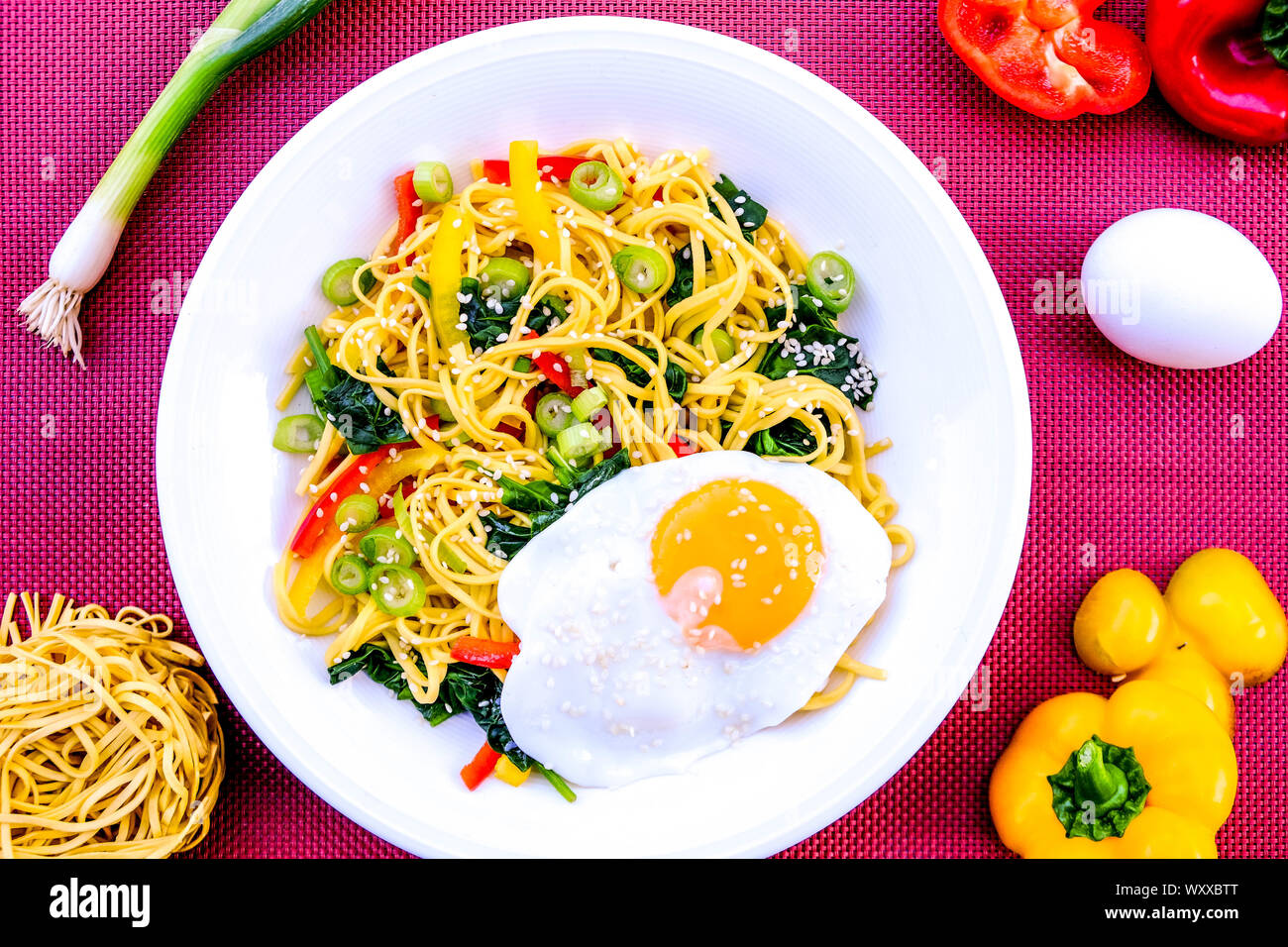 Egg Noodle and Pepper Salad With Red and Yellow Peppers, Spinach, Spring Onions, Sesame Seeds