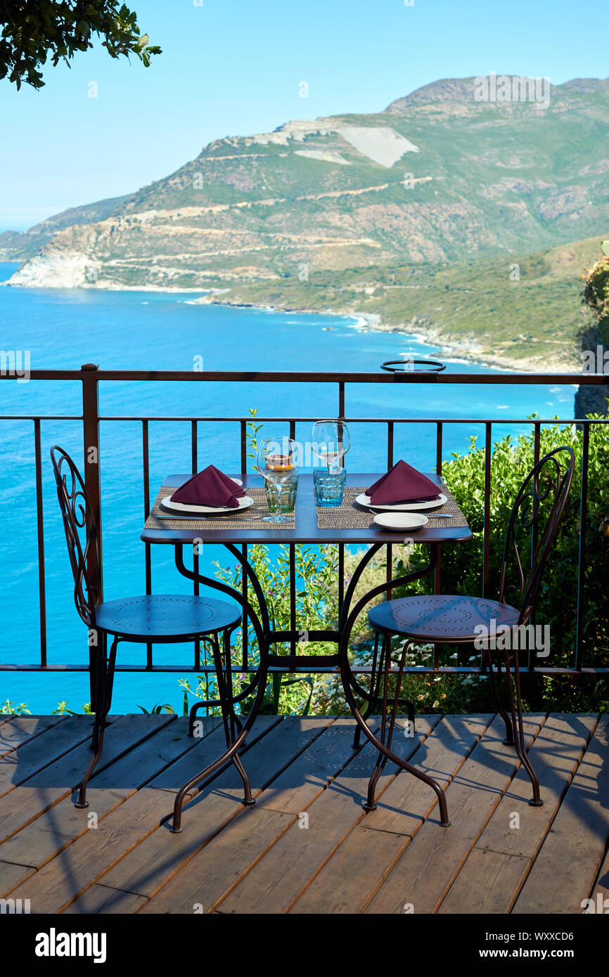 Cafe restaurant dining tables overlooking Nonza beach landscape in the Haute-Corse department Cap Corse north Corsica France. Stock Photo