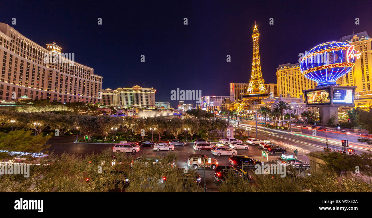 A skyline nighttime view of several casino's and resort on Las Vegas Blvd in Las Vegas, Nevada including the Fountains at Bellagio water show. Stock Photo