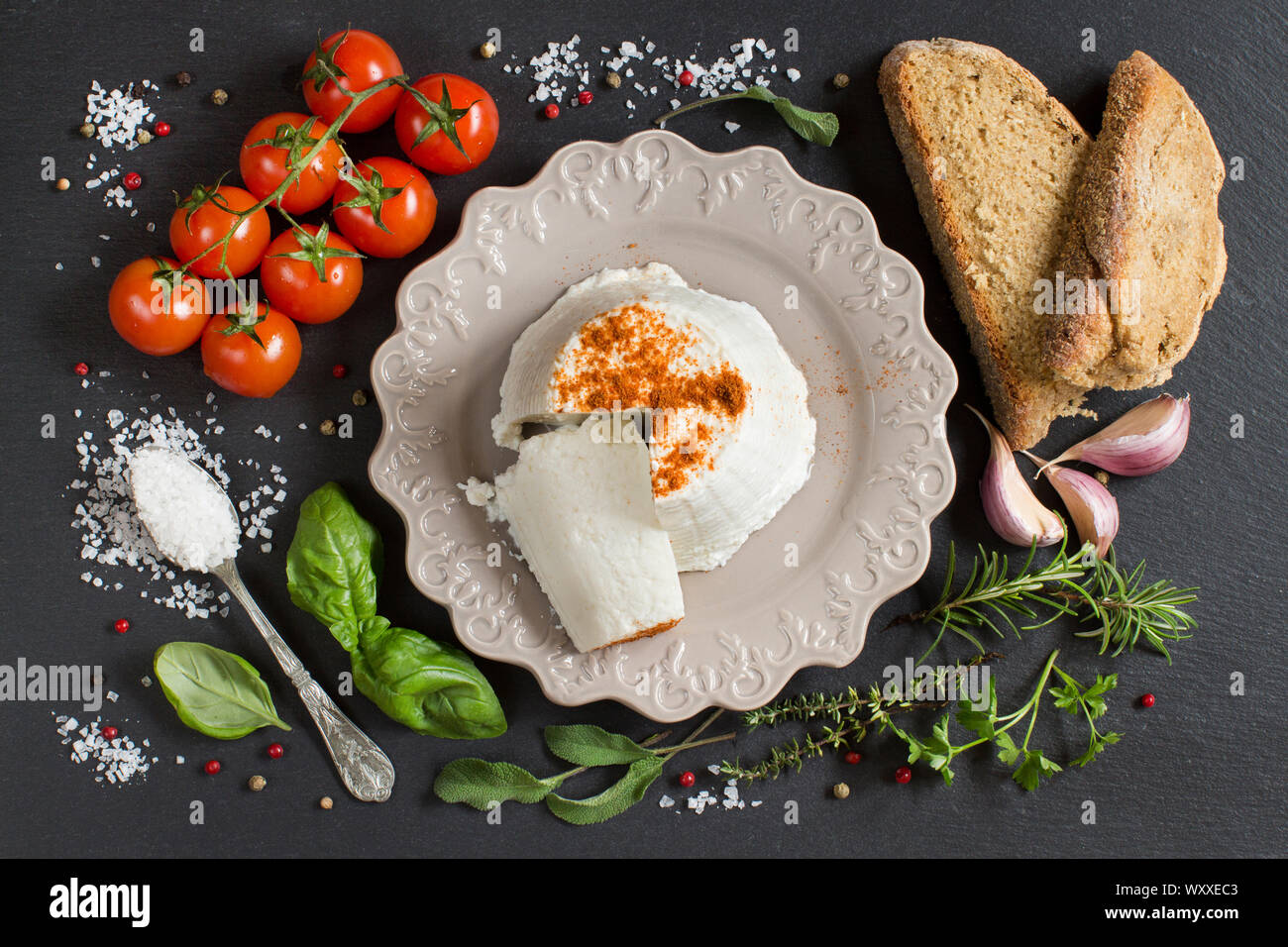 Italian ricotta cheese, homemade bread, vegetables and herbs top view ...