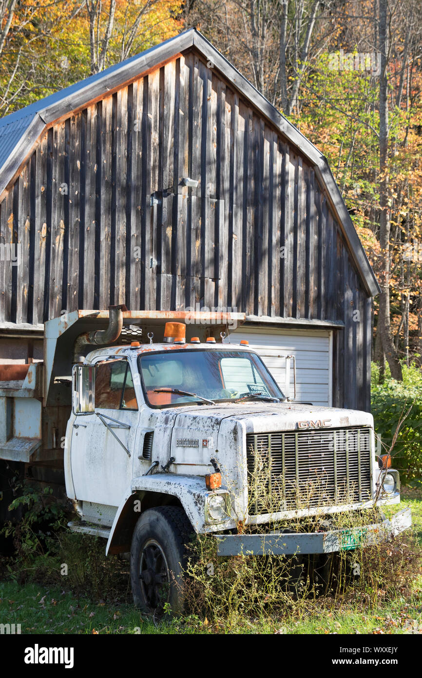 Old GMC truck by traditional and typical old barn in Vermont, New England, USA Stock Photo