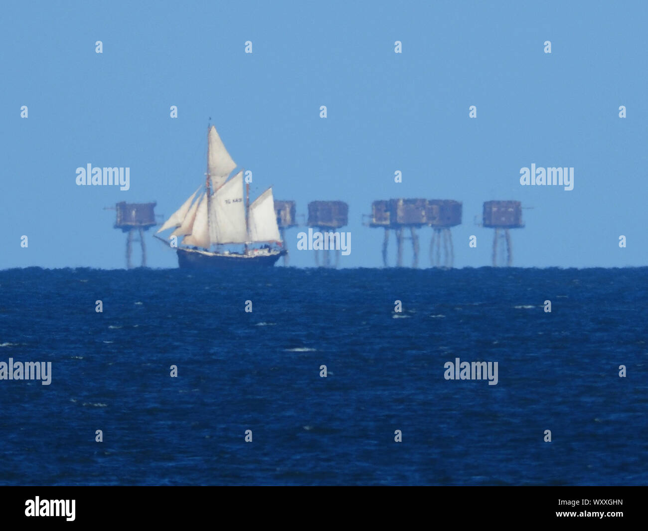 Sheerness, Kent, UK. 18th September, 2019. Classic sailing yacht 'Queen Galadriel' operated by the Cirdan Sailing Trust seen sailing across the Thames Estuary in front of the wartime Red Sands Towers. Credit: James Bell/Alamy Live News Stock Photo