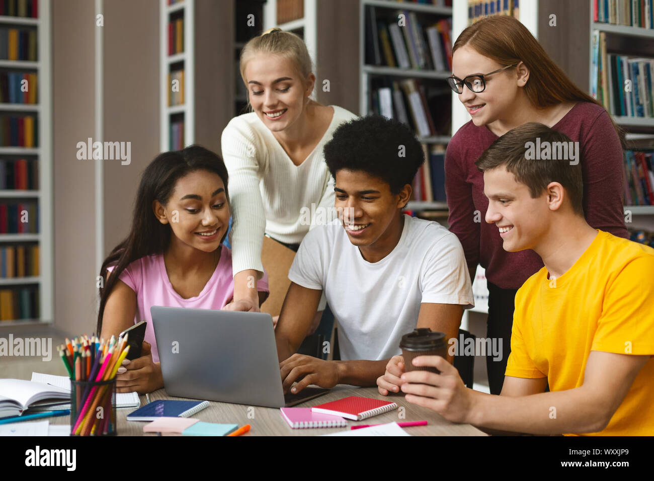 Group of international classmates checking on new project Stock Photo