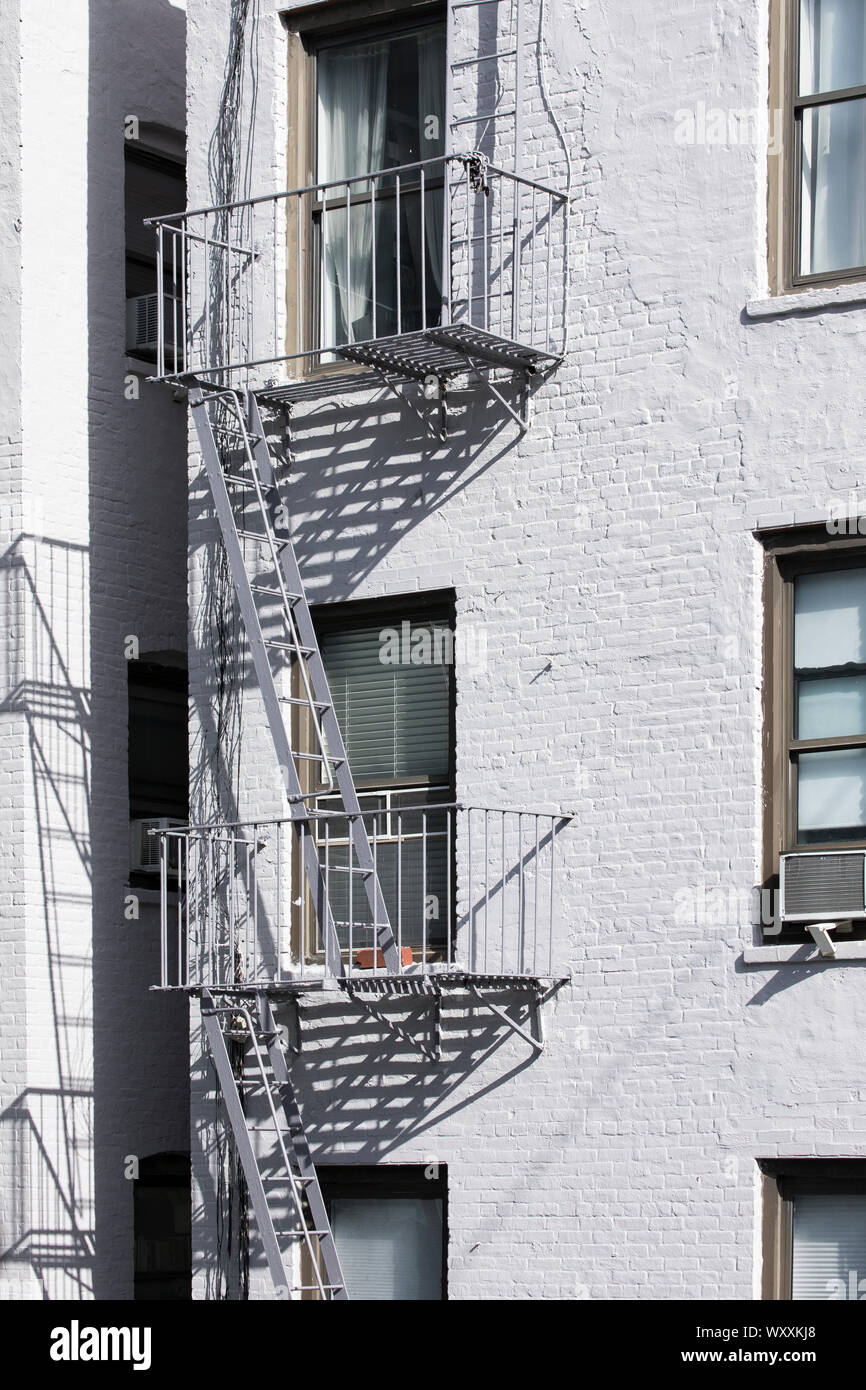 Traditional typical metal fire escape ladder on walkup brownstone