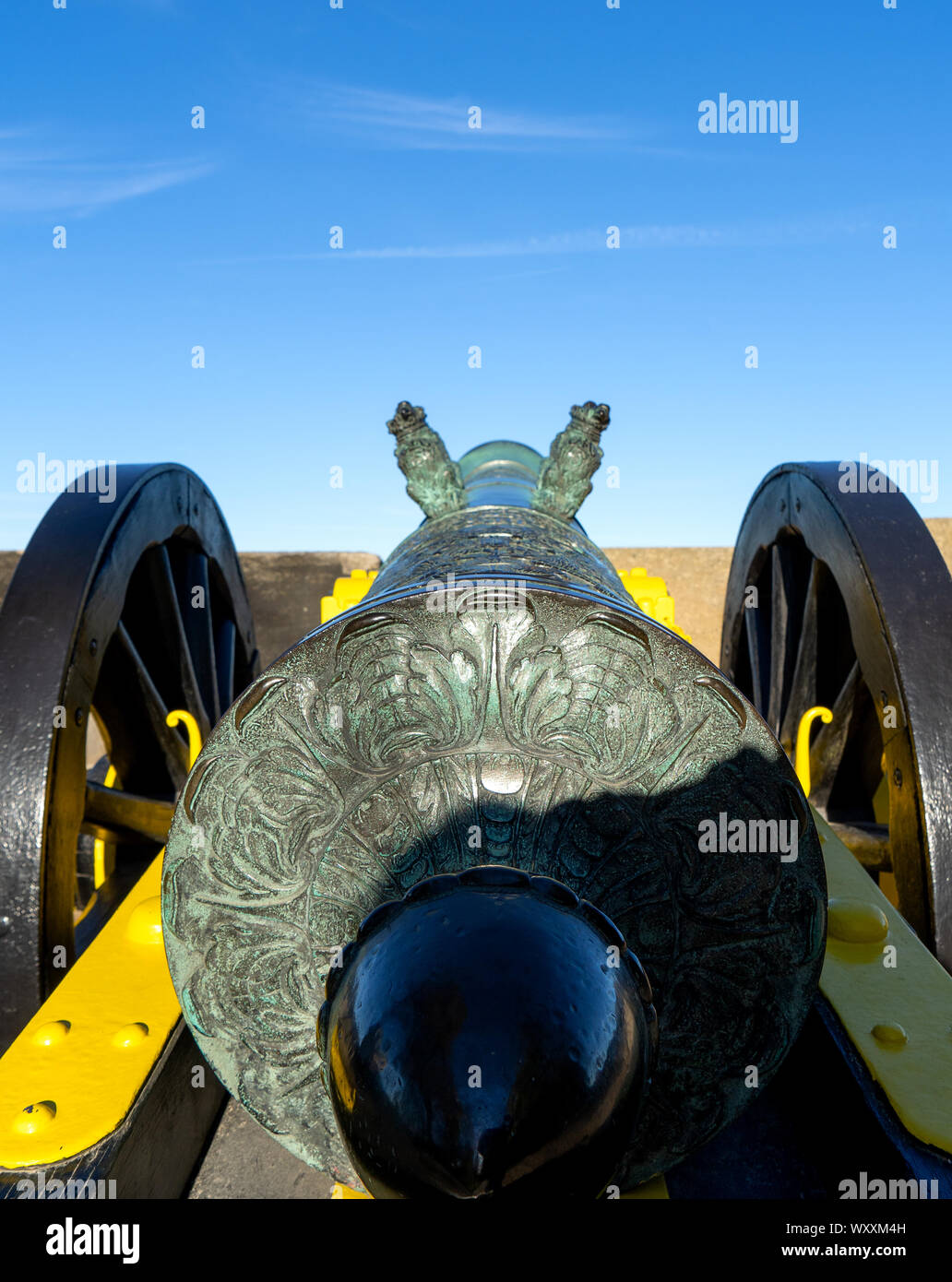 Looking along the back of an old muzzle loaded gun aiming away from the fortress. Such guns were made out of special bronze alloys. Those guns were on Stock Photo