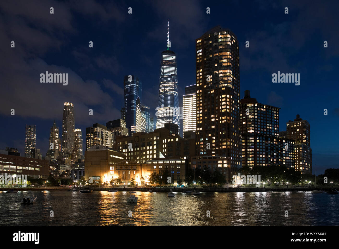 New York skyline at night showing the famous Freedom Tower (in place of the World Trade Centre) and the Hudson River from Pier 25 Stock Photo