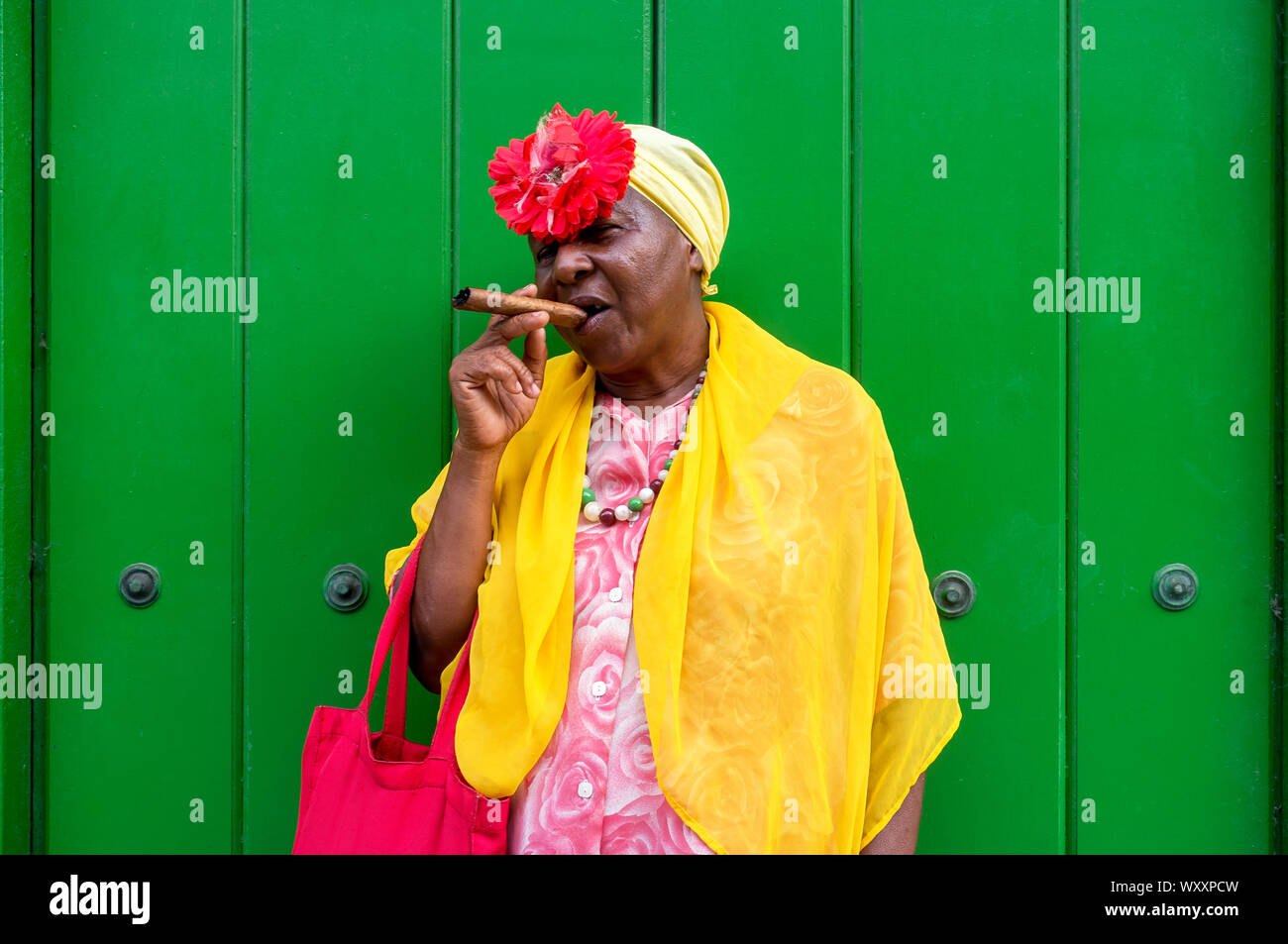 Old school Cuban lady smoking a large cigar in Havana, Cuba Stock Photo