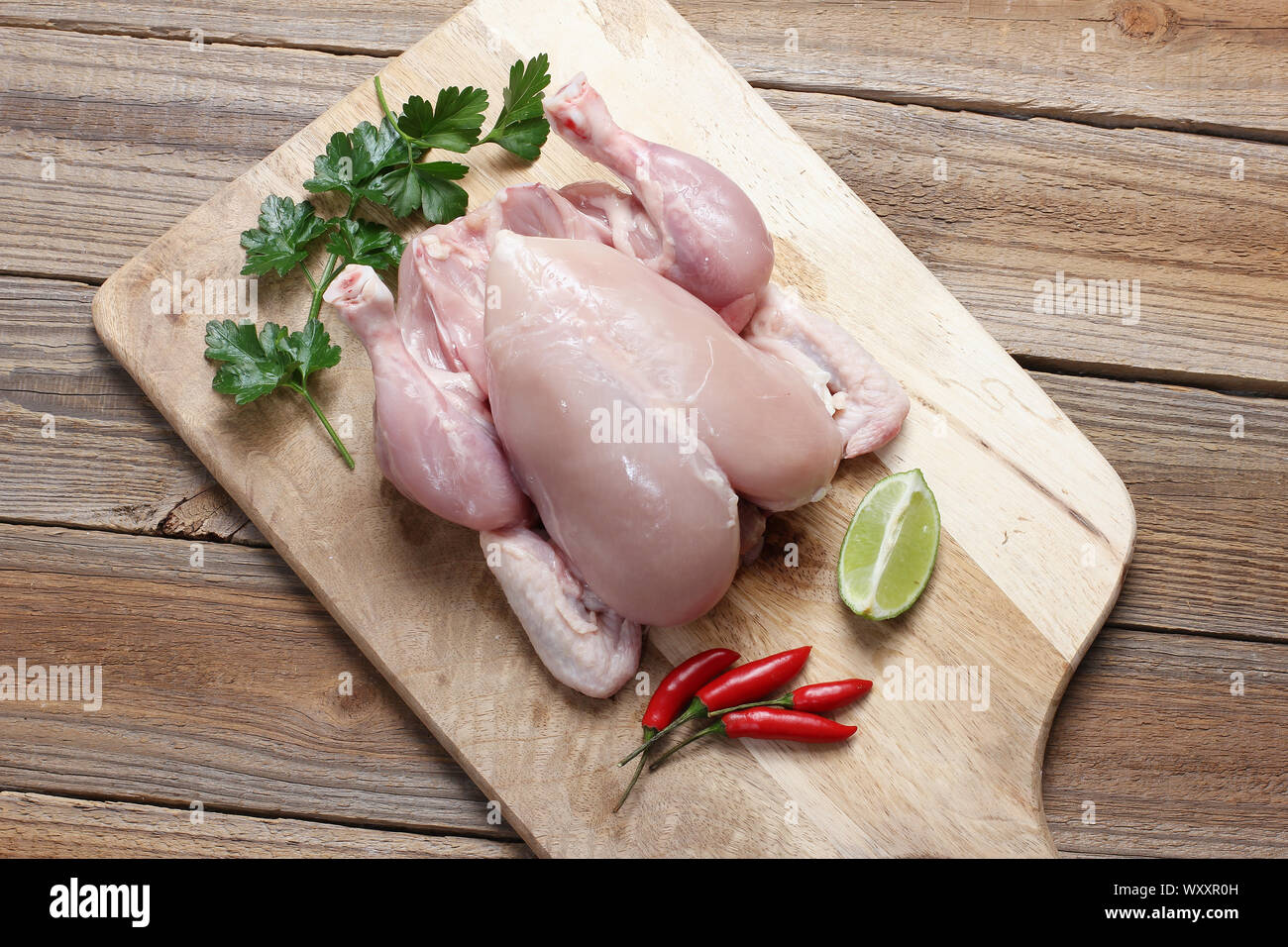 Skinless Whole Chicken on Chopping Board Stock Photo Alamy