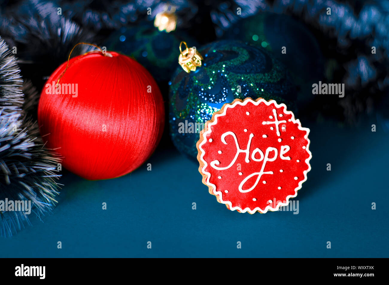 Christmas card: A red Christmas tree toy lies on a blue background Stock Photo - Alamy