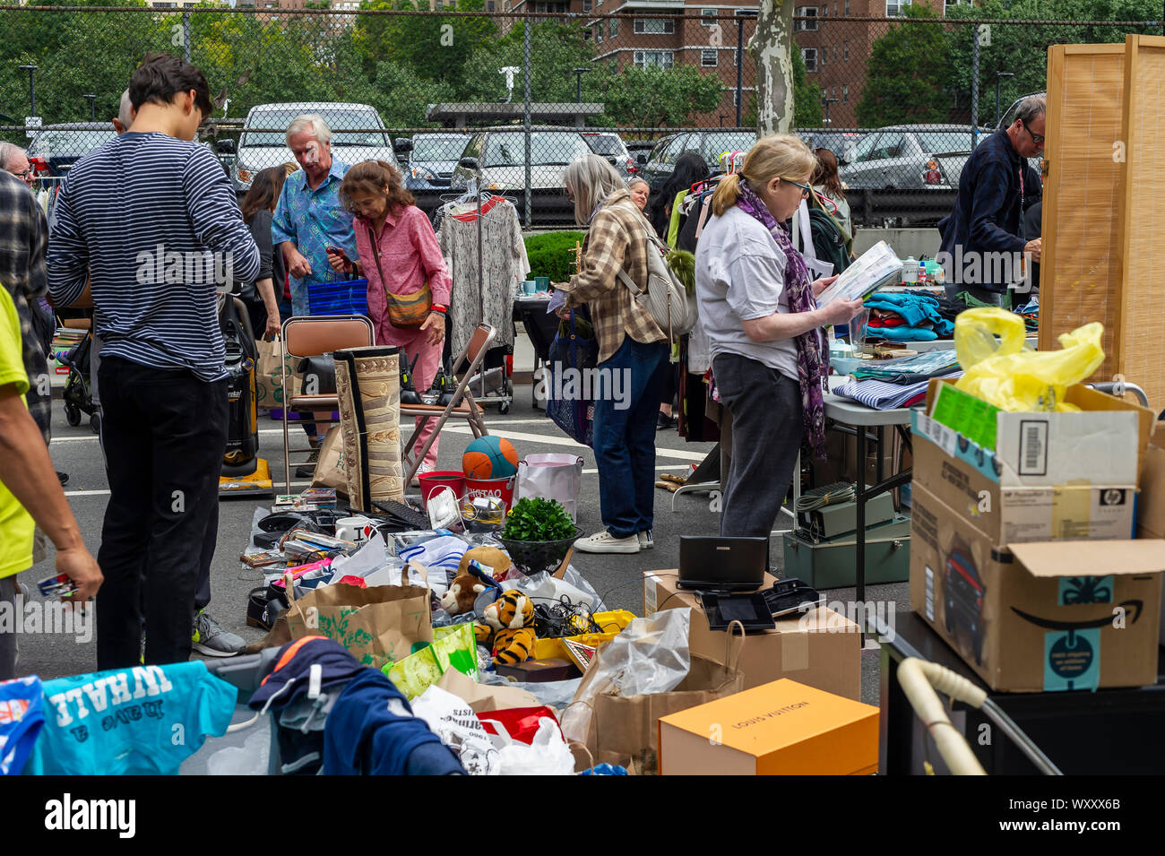 Shoppers search for bargains at the humongous 35th Annual Penn South Flea Market in the New York neighborhood of Chelsea on Saturday, September 14, 2019. The flea market appears like Brigadoon, only once every year, and the residents of the 20 building Penn South cooperatives have a closet cleaning extravaganza. Shoppers from around the city come to the flea market which attracts thousands passing through.  (© Richard B. Levine) Stock Photo