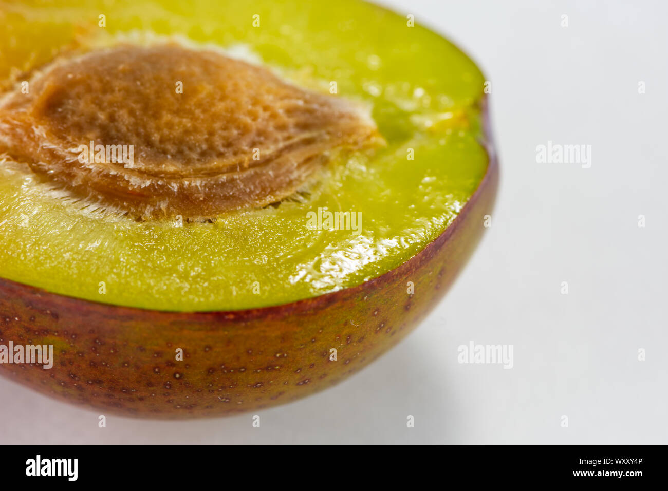 Fresh plum close up photography in white background. Stock Photo