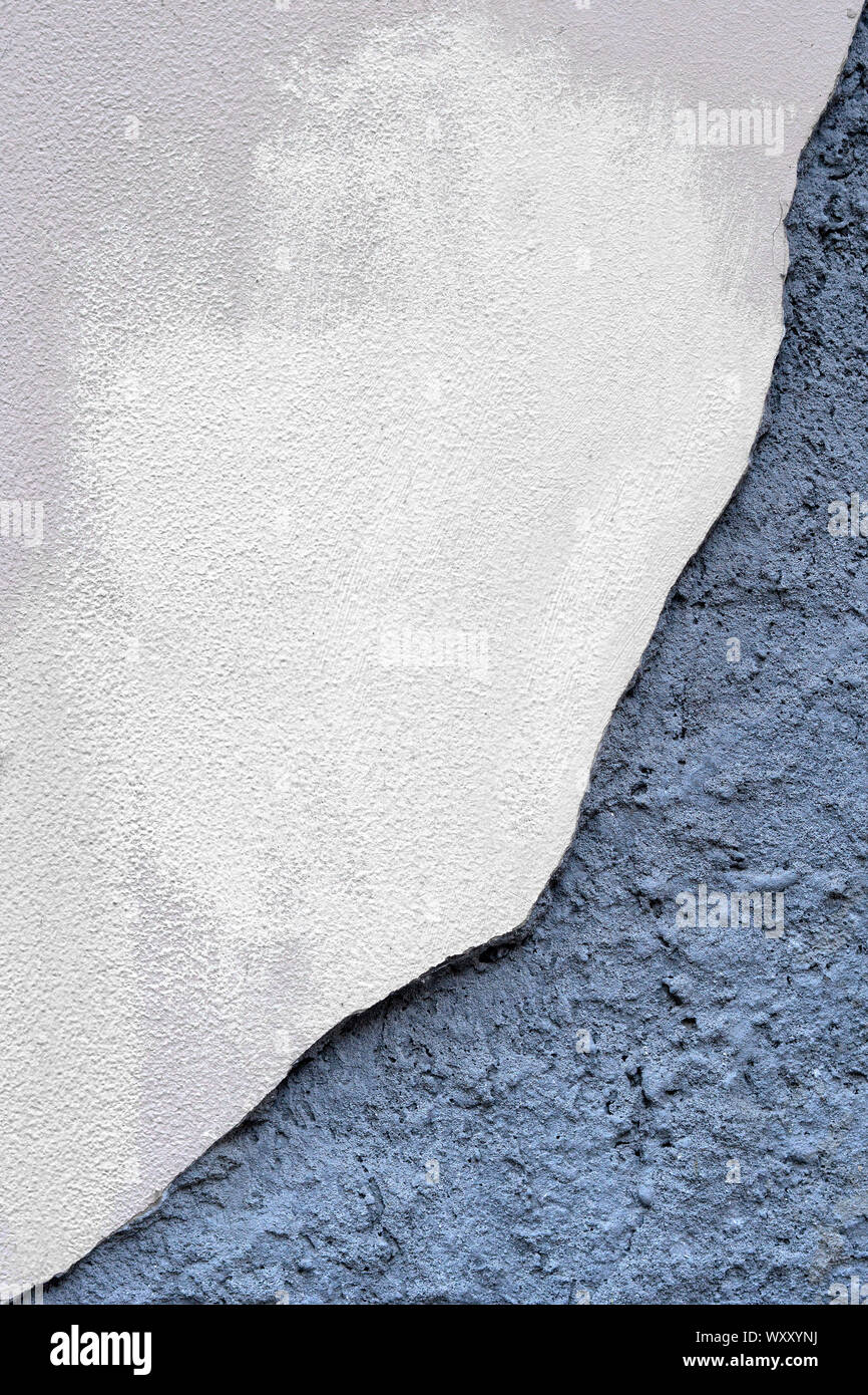 Concrete wall with partially damaged plaster. Stock Photo