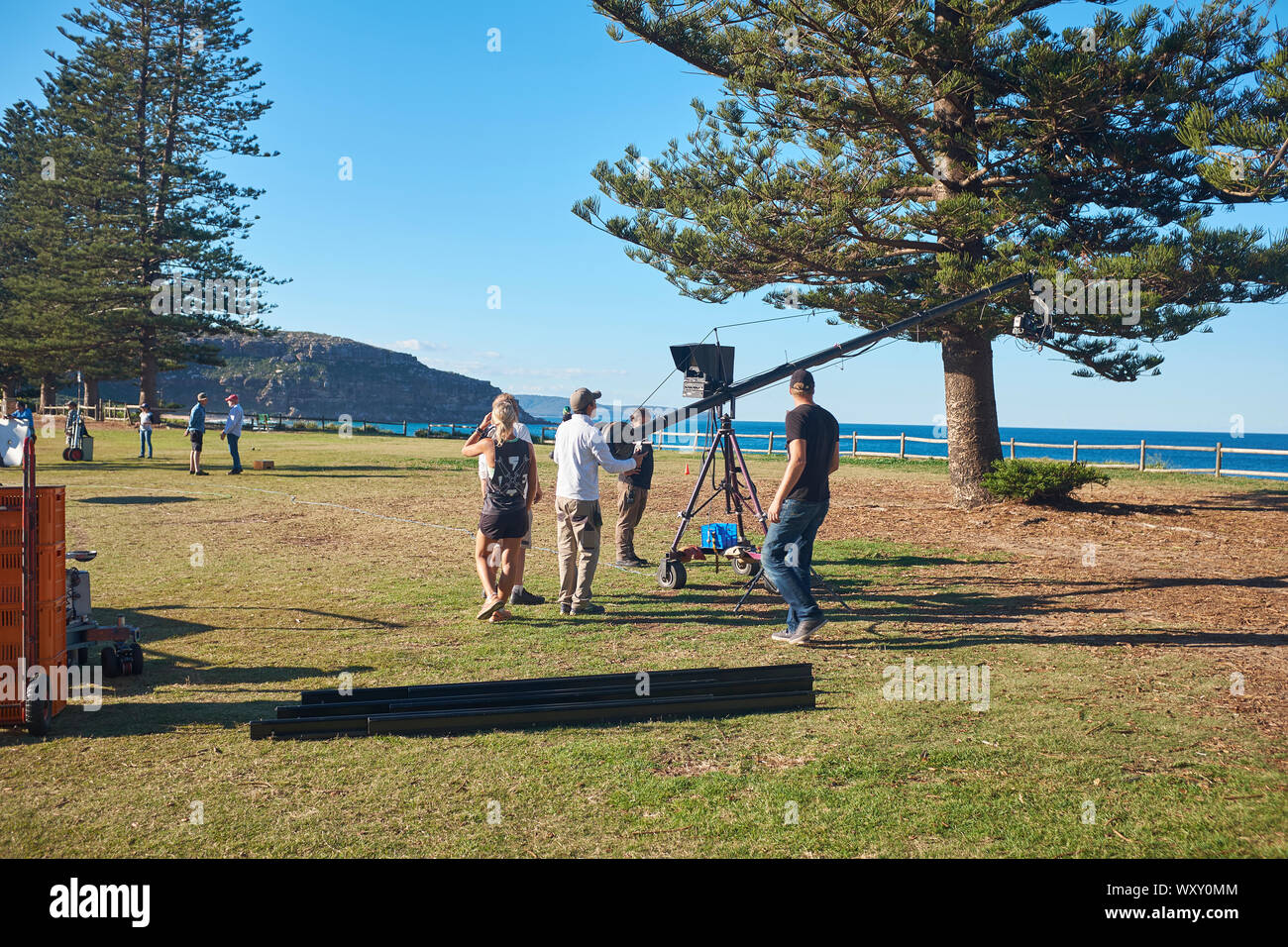 TV crew with camera on a boom or jib preparing to film an outdoor scene of Home & Away television programme at Palm Beach, New South Wales, Australia Stock Photo