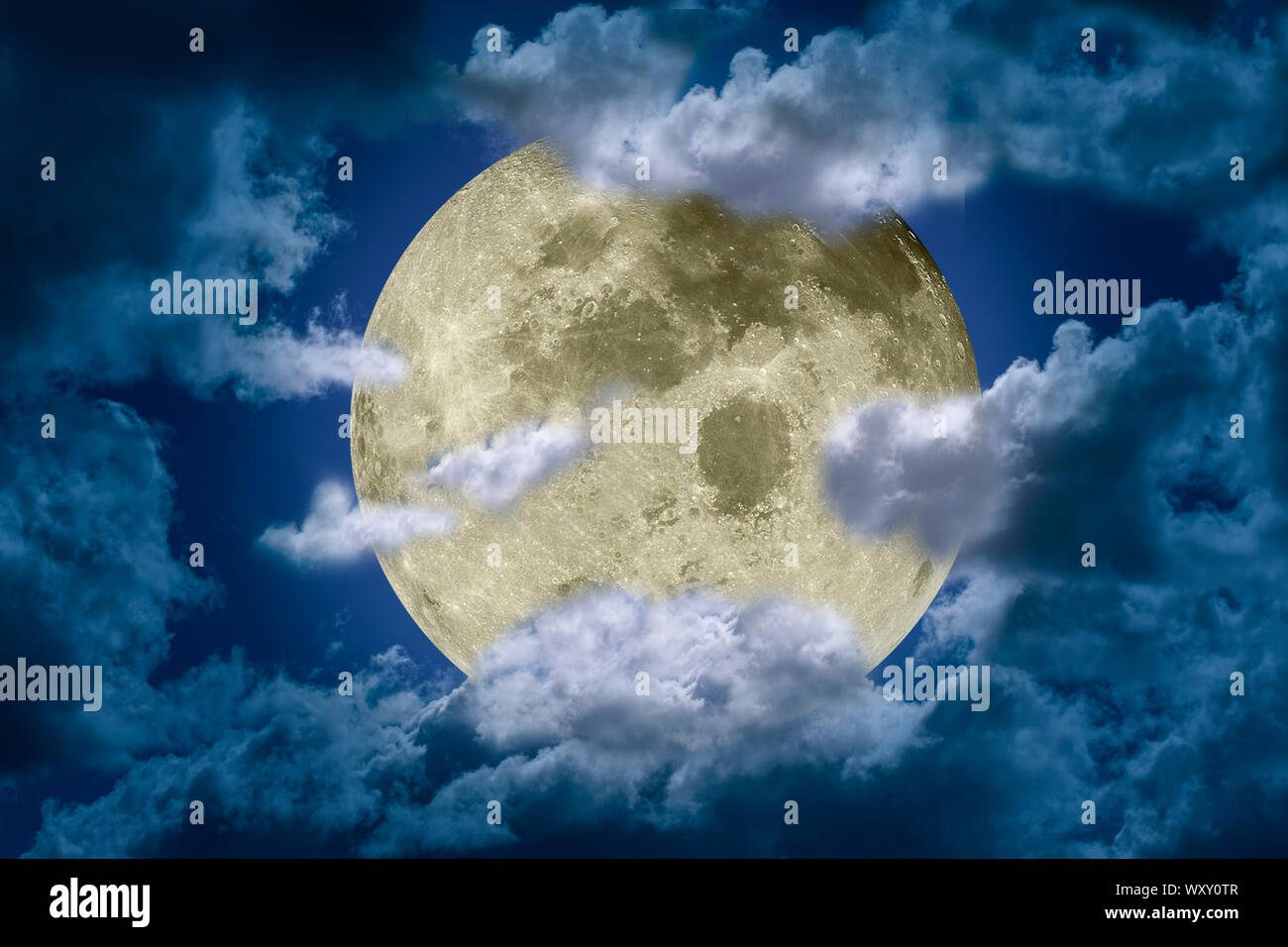 Big bright and shining full moon somewhat hidden behind clouds against a dark night sky. Fantasy illustration. Elements of this image furnished by NAS Stock Photo