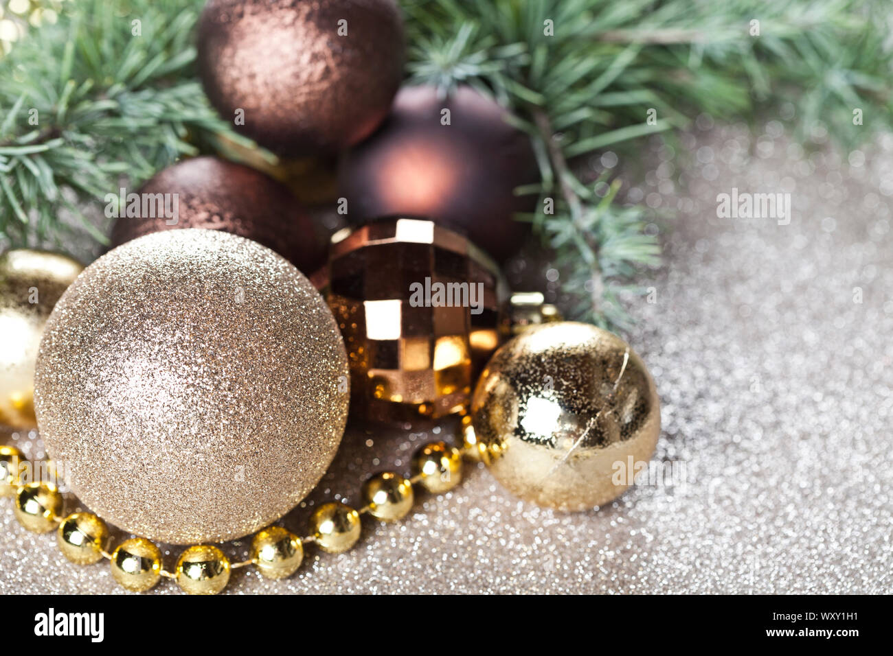 Christmas decorations and evergreen fir tree branch closeup on gold ...