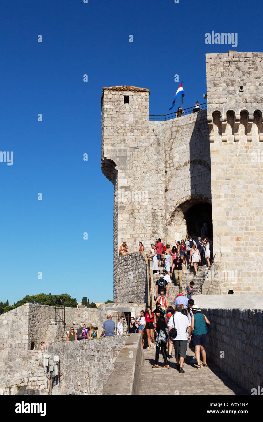 Dubrovnik city walls travel; tourists climbing to Fort Minceta, the highest point on the city wall, Dubrovnik old town, Dubrovnik Croatia Europe Stock Photo