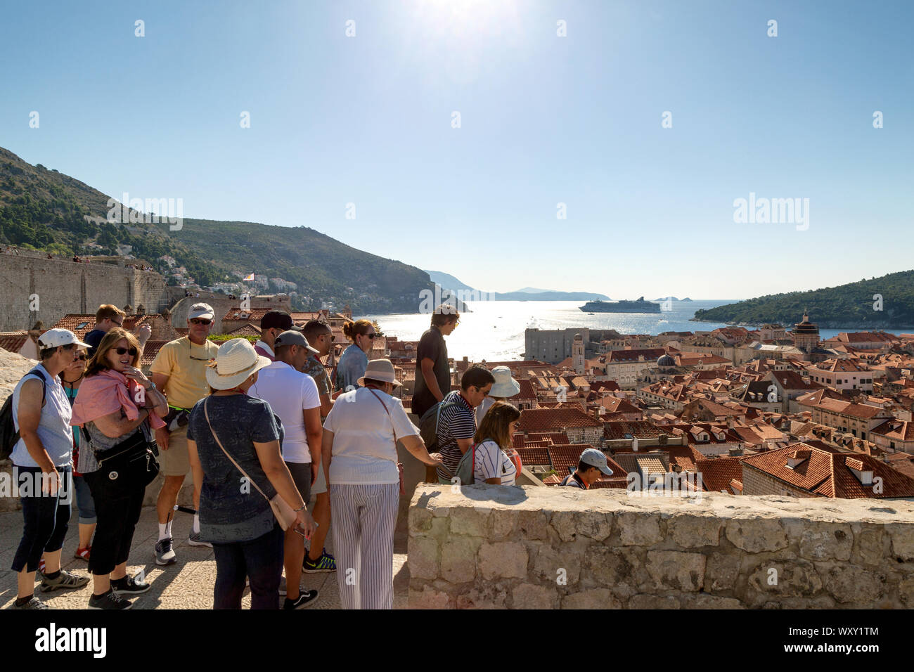 Dubrovnik city walls; people walking the city wall, Dubrovnik old town UNESCO World Heritage site, Dubrovnik Croatia Europe Stock Photo