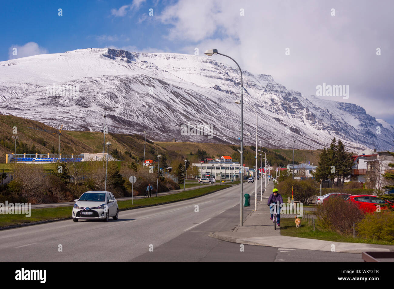 SAUDARKROKUR, ICELAND - Automobiles on road in town, and surrounding mountains. Stock Photo